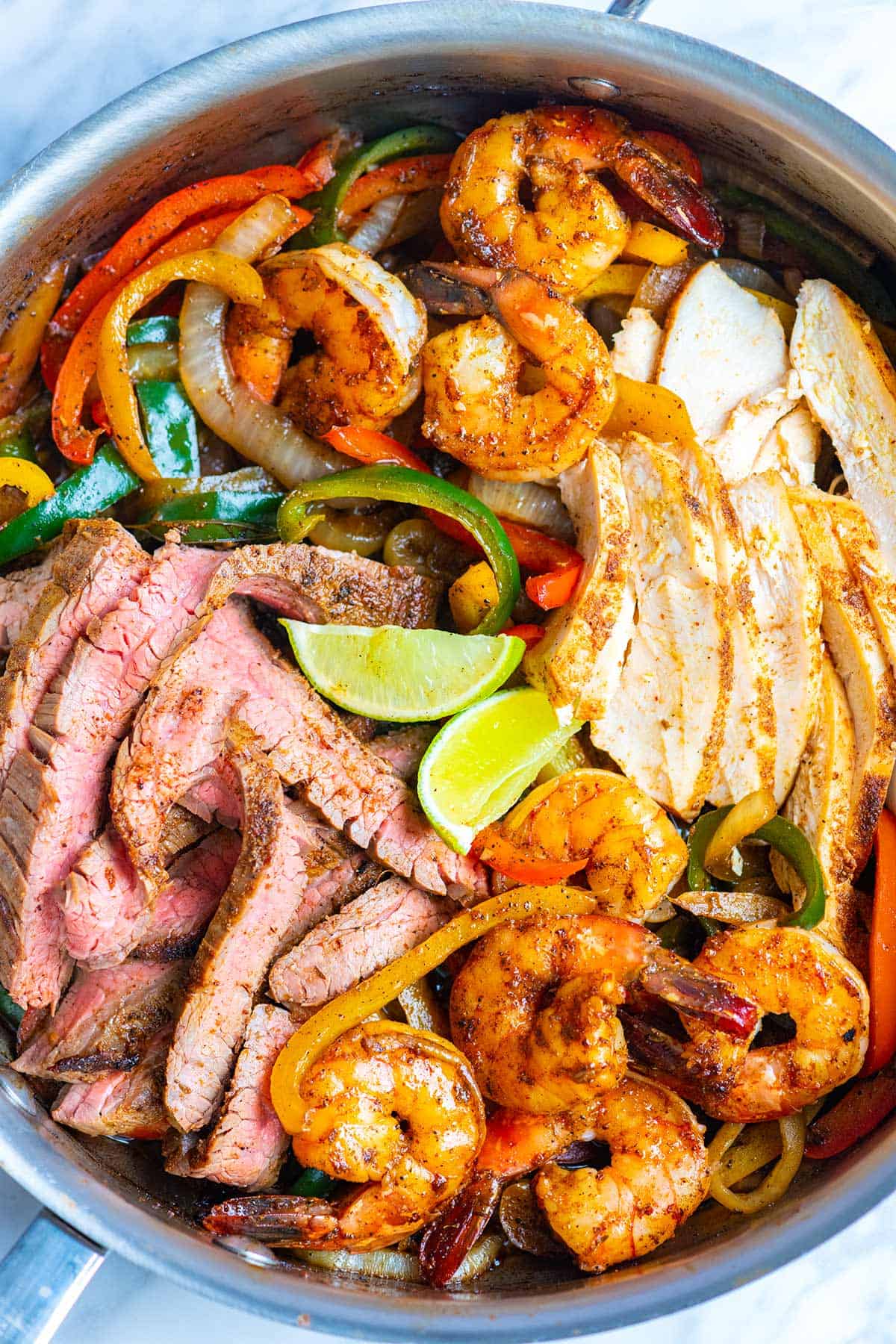 Steak, chicken, and shrimp fajitas ready to serve.