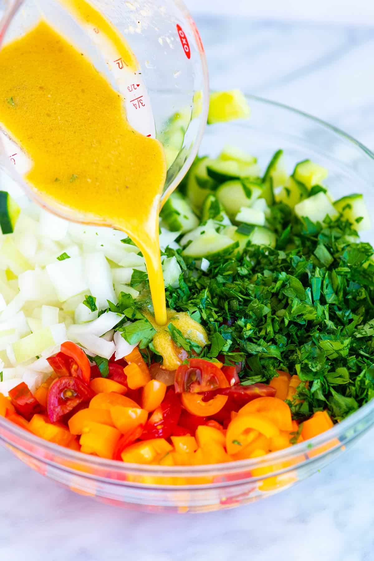Pouring dressing over salad ingredients