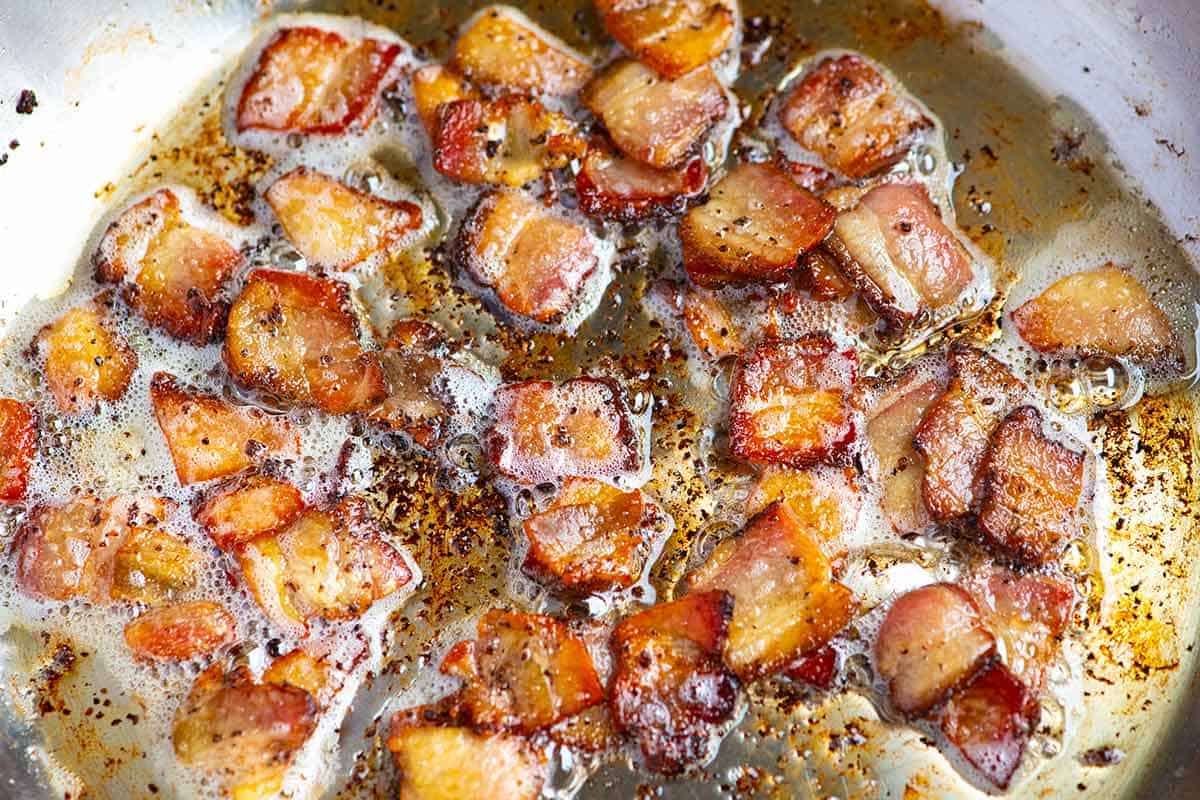 Bacon cooking in a pan for fried cabbage