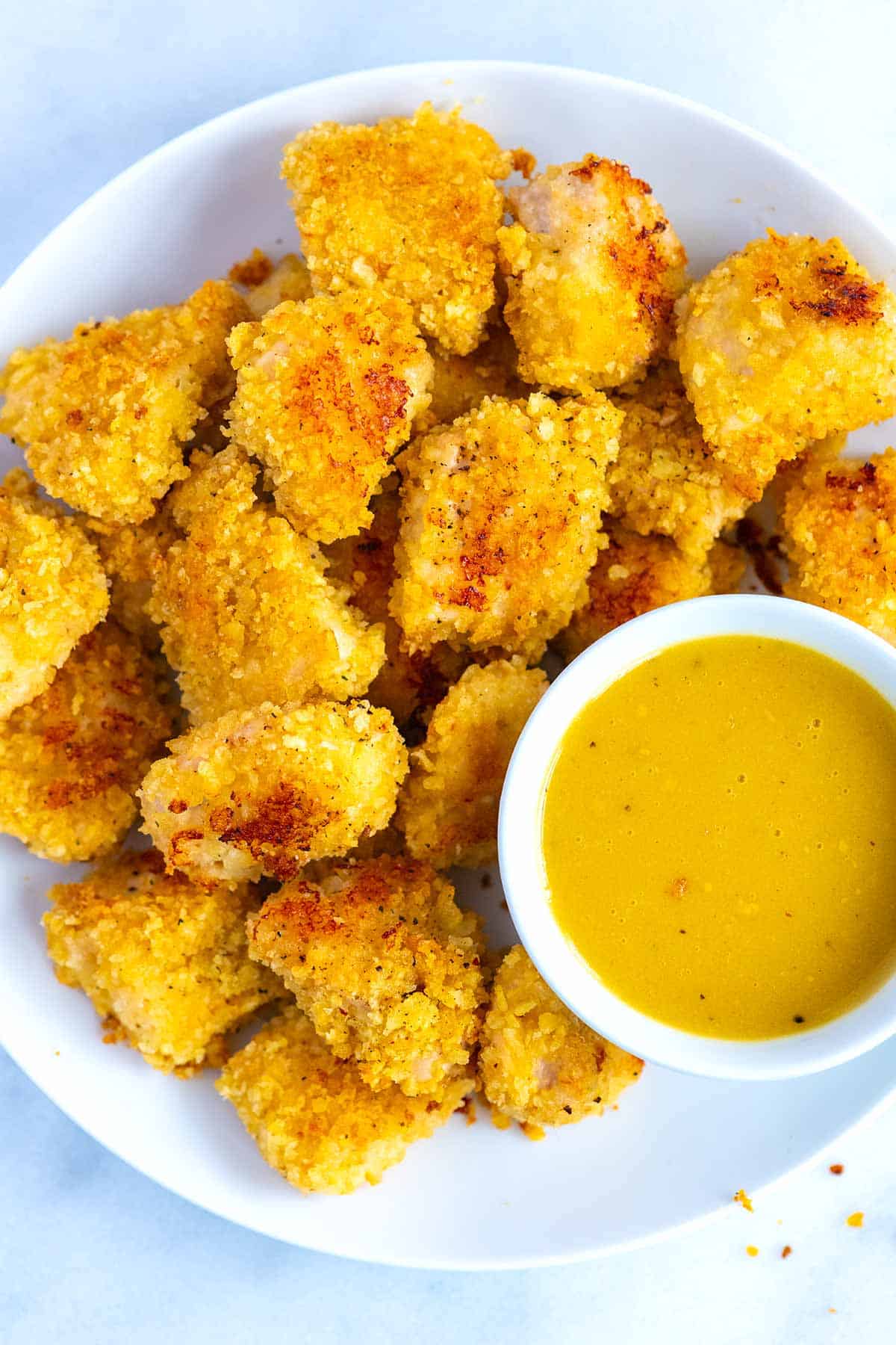 Crispy Baked Homemade Chicken Nuggets with honey mustard sauce.