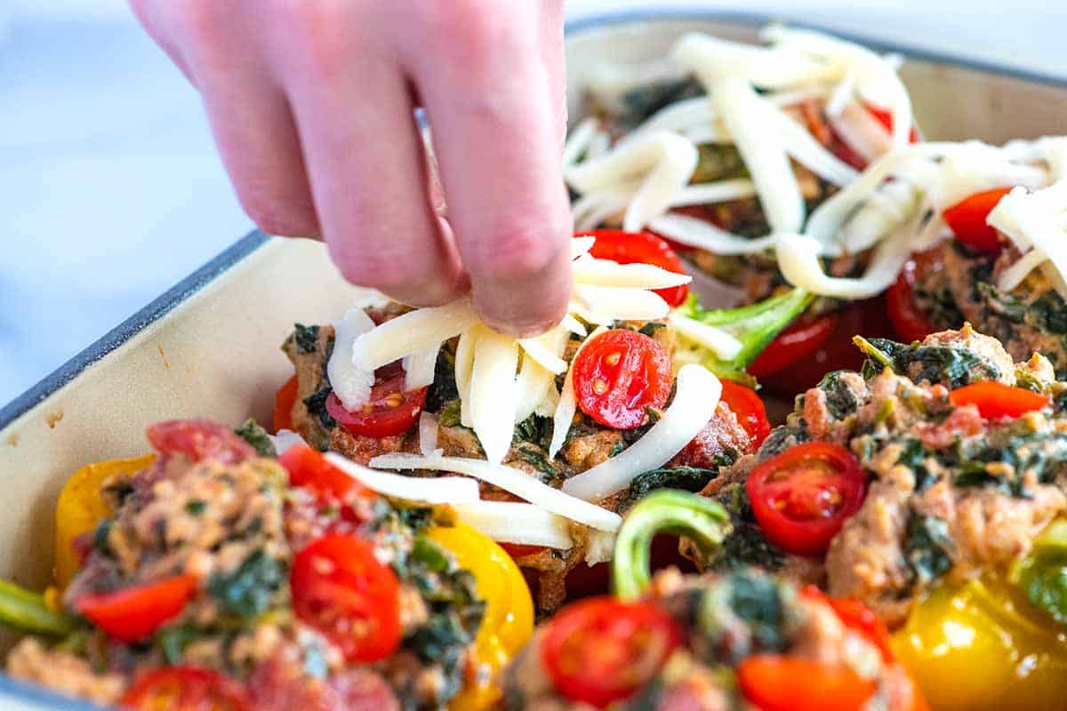Topping stuffed peppers with cheese