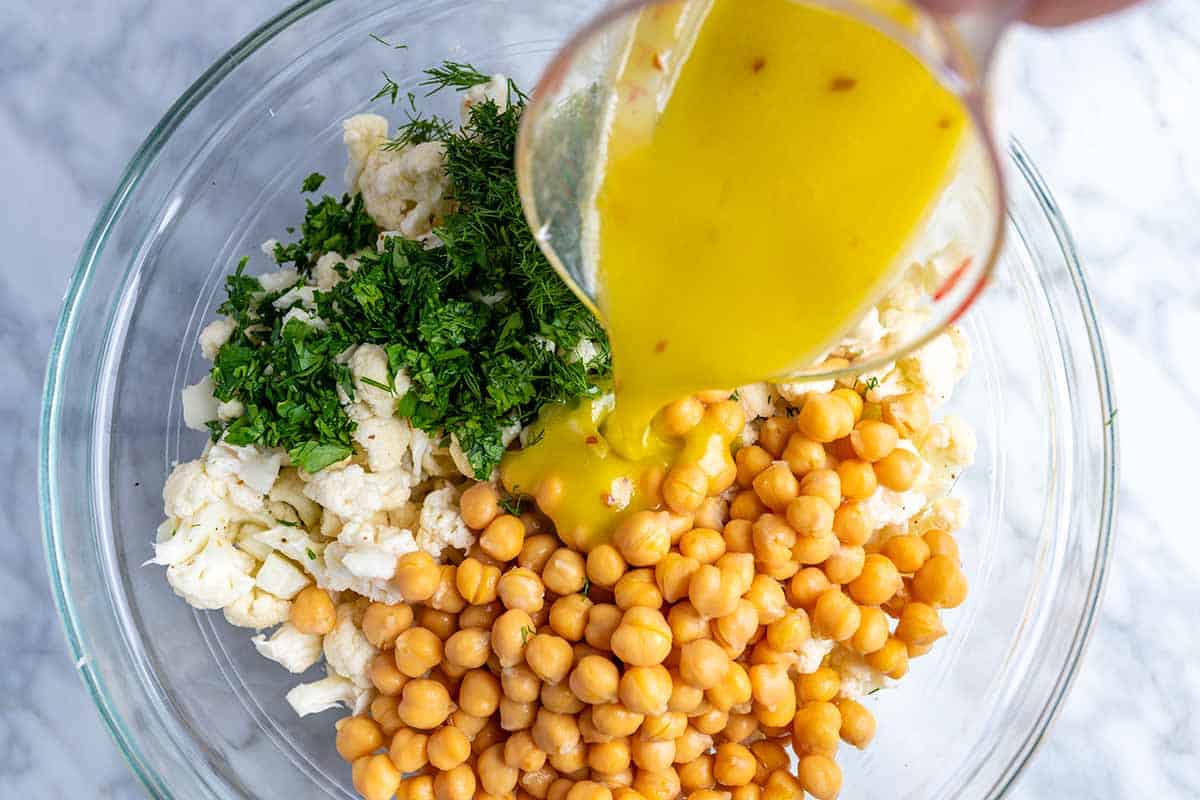 Mixing the cauliflower salad ingredients