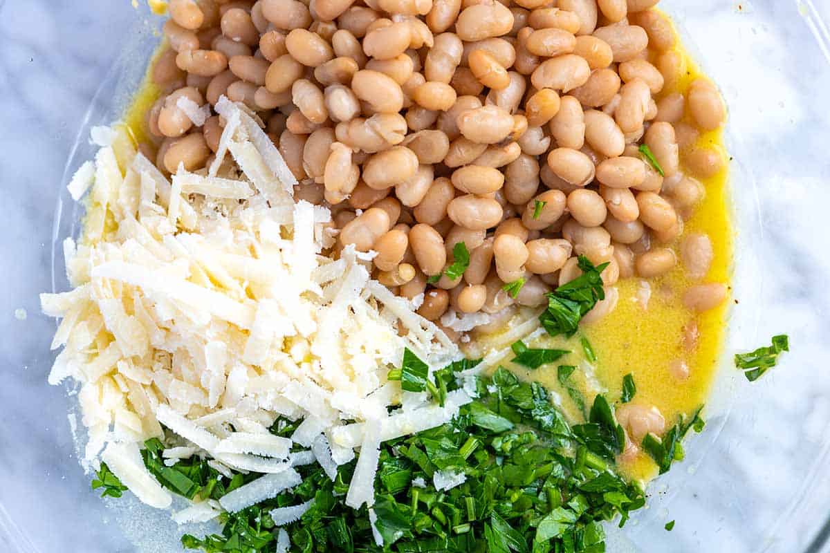 How to Make White Bean Salad with Prosciutto: Adding white beans to the dressing