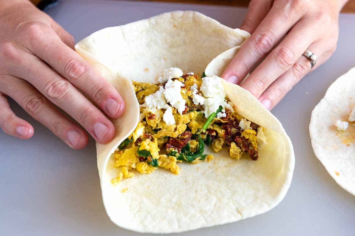 How to Make Breakfast Burritos: Rolling up the eggs in the tortilla