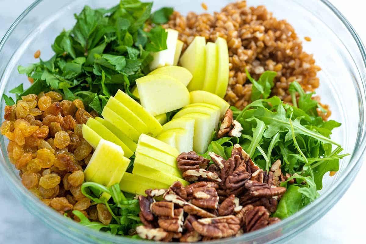 Farro salad Ingredients in a bowl ready to be tossed