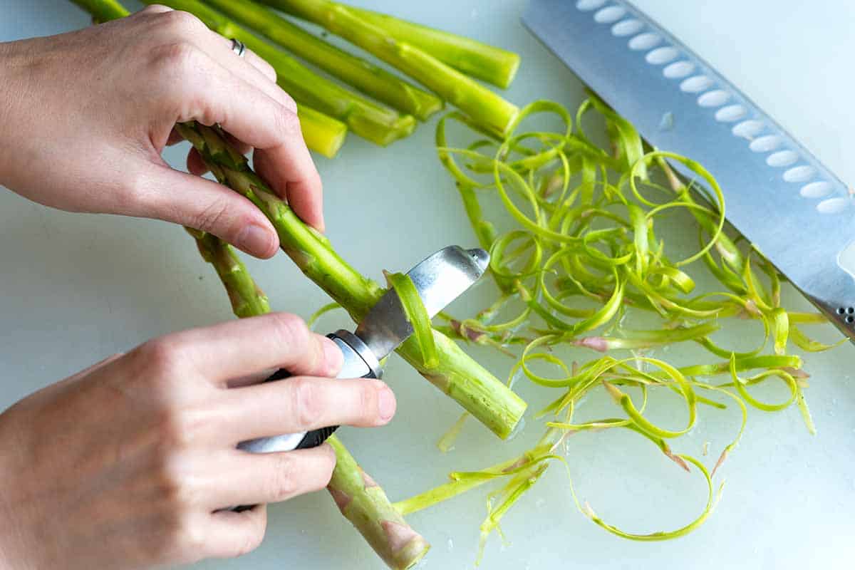 Peeling thicker asparagus spears for roasting.