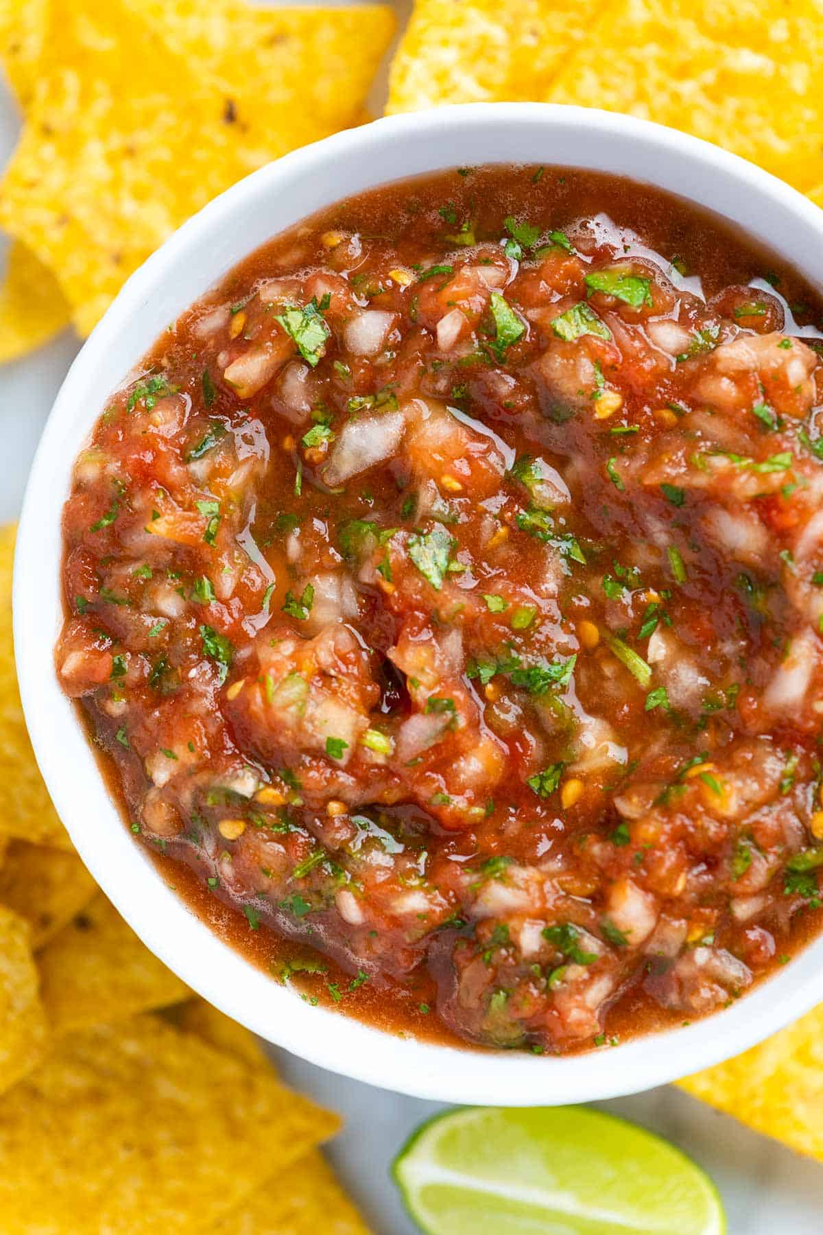Homemade salsa surrounded by tortilla chips