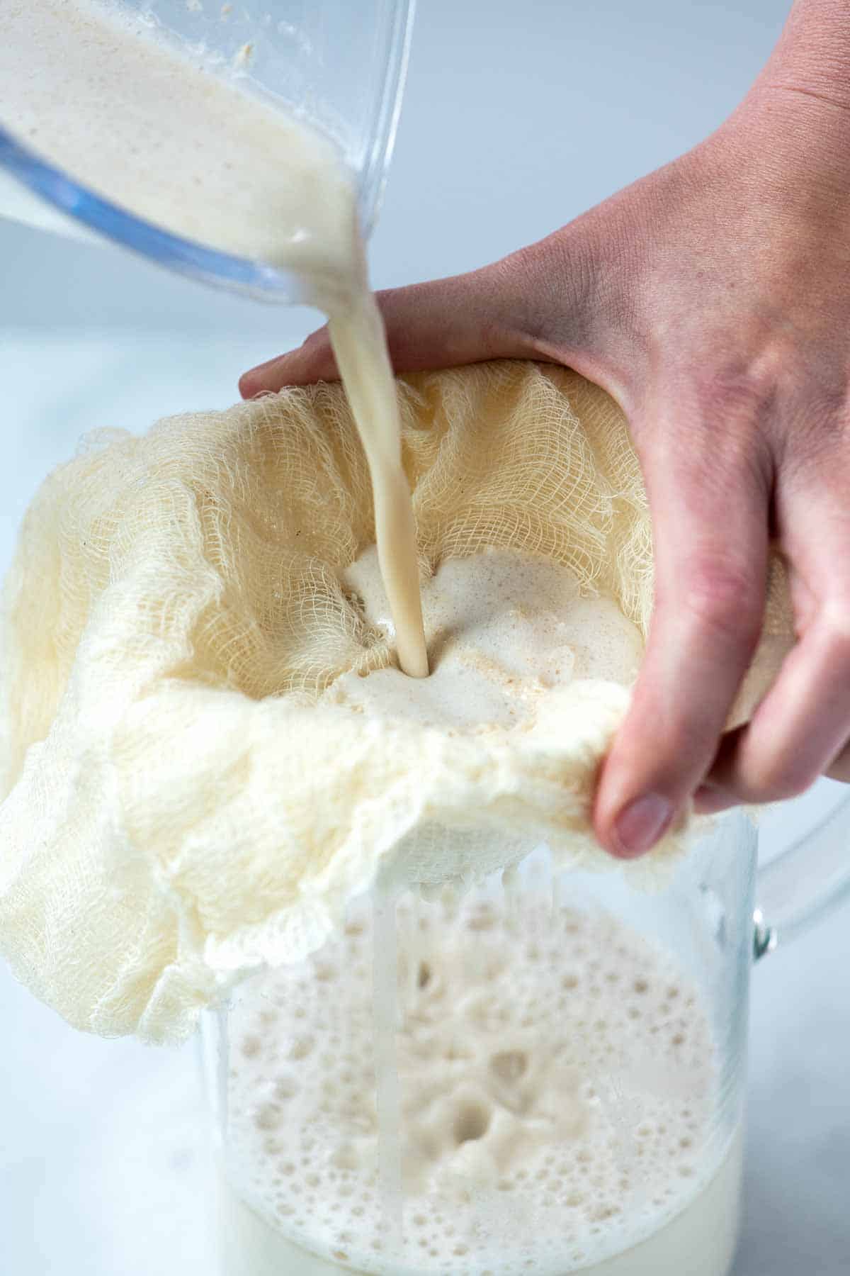 How to Make Oat Milk: Straining homemade oat milk.