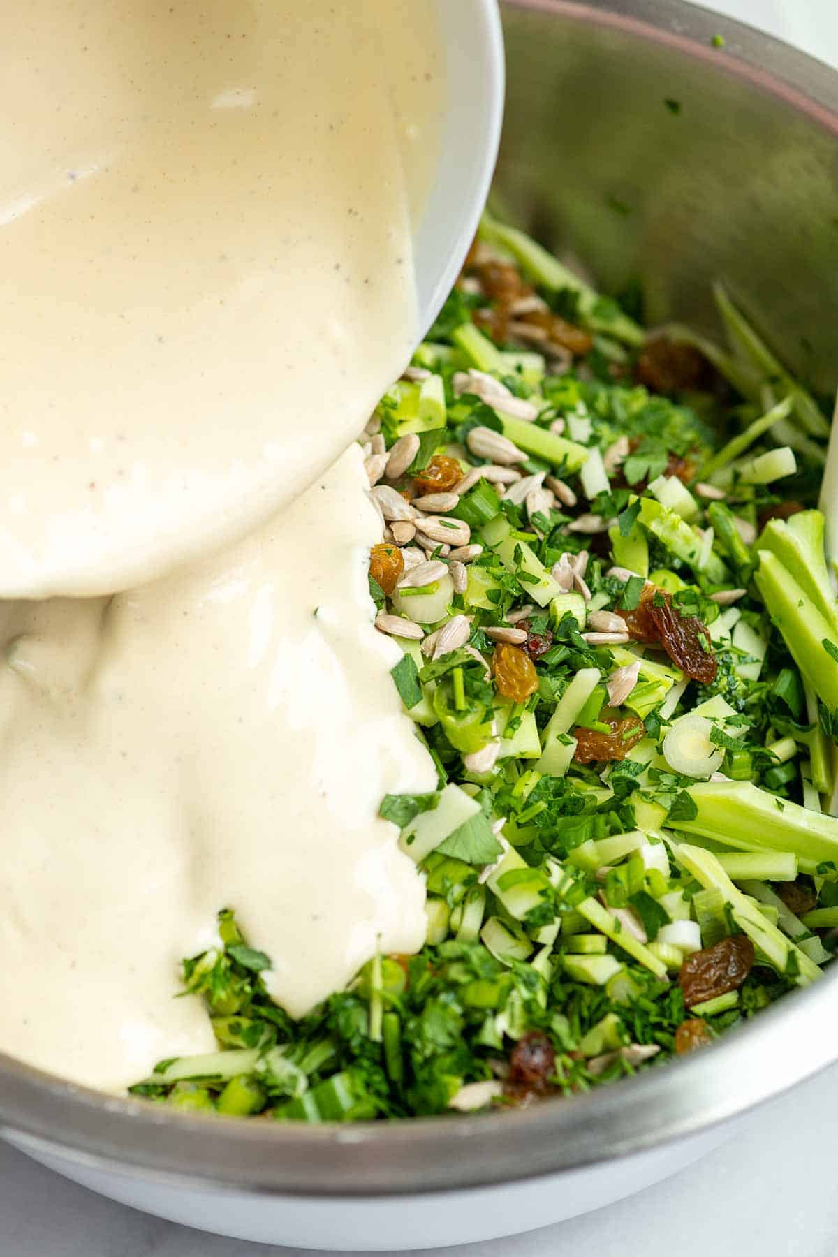 Adding a creamy broccoli slaw dressing to the ingredients