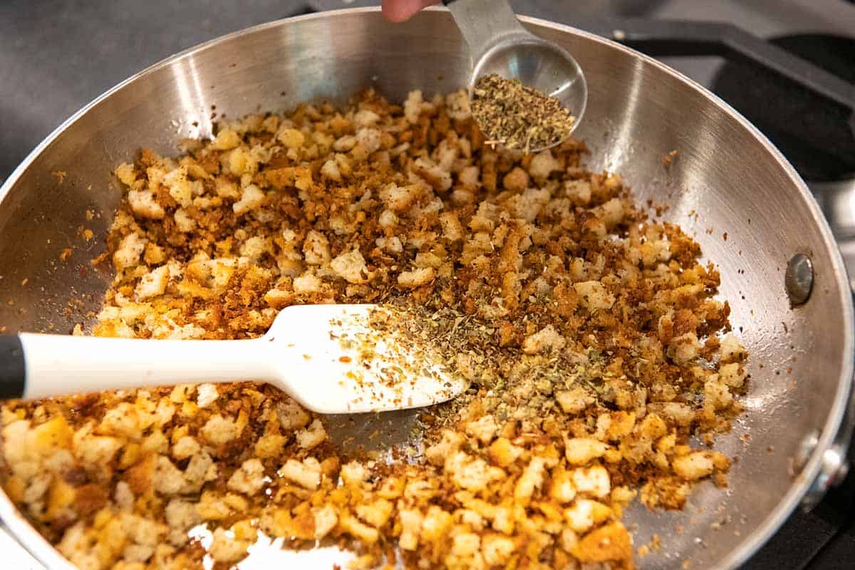 Toasting bread crumbs in a skillet with spices.