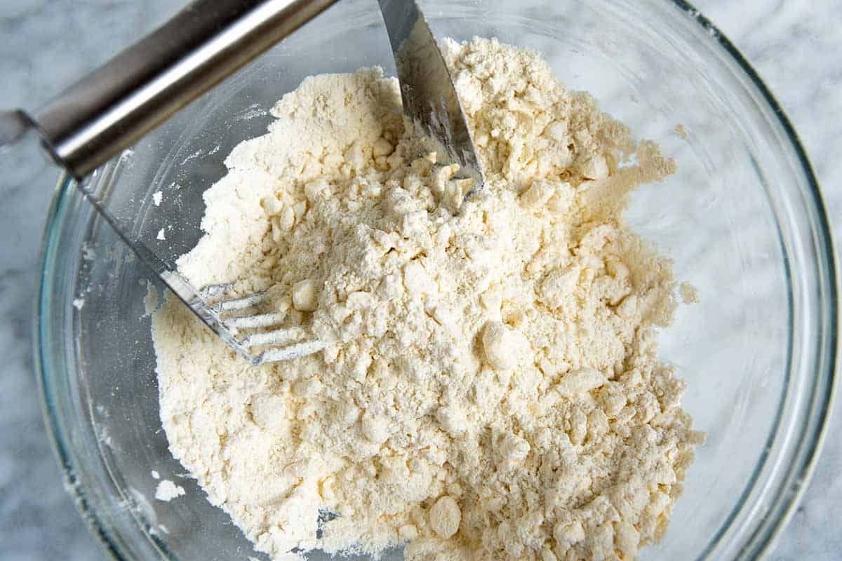 Cutting the butter into the flour to make drop biscuits.