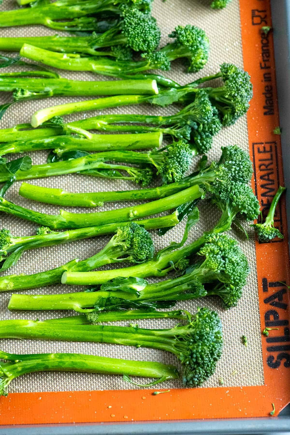 Broccolini on a baking sheet ready to be roasted