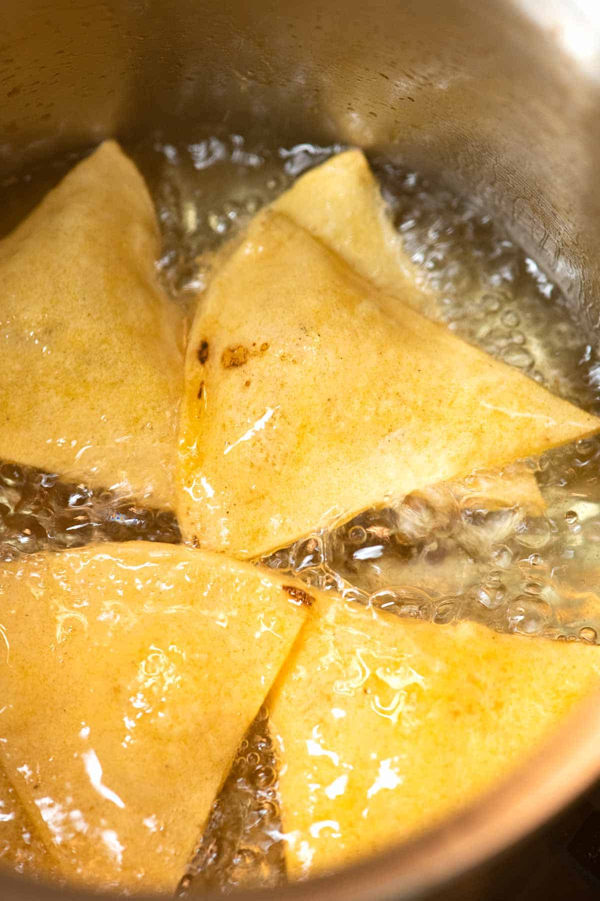 How to Make Tortilla Chips at Home: Tortilla chips frying in oil