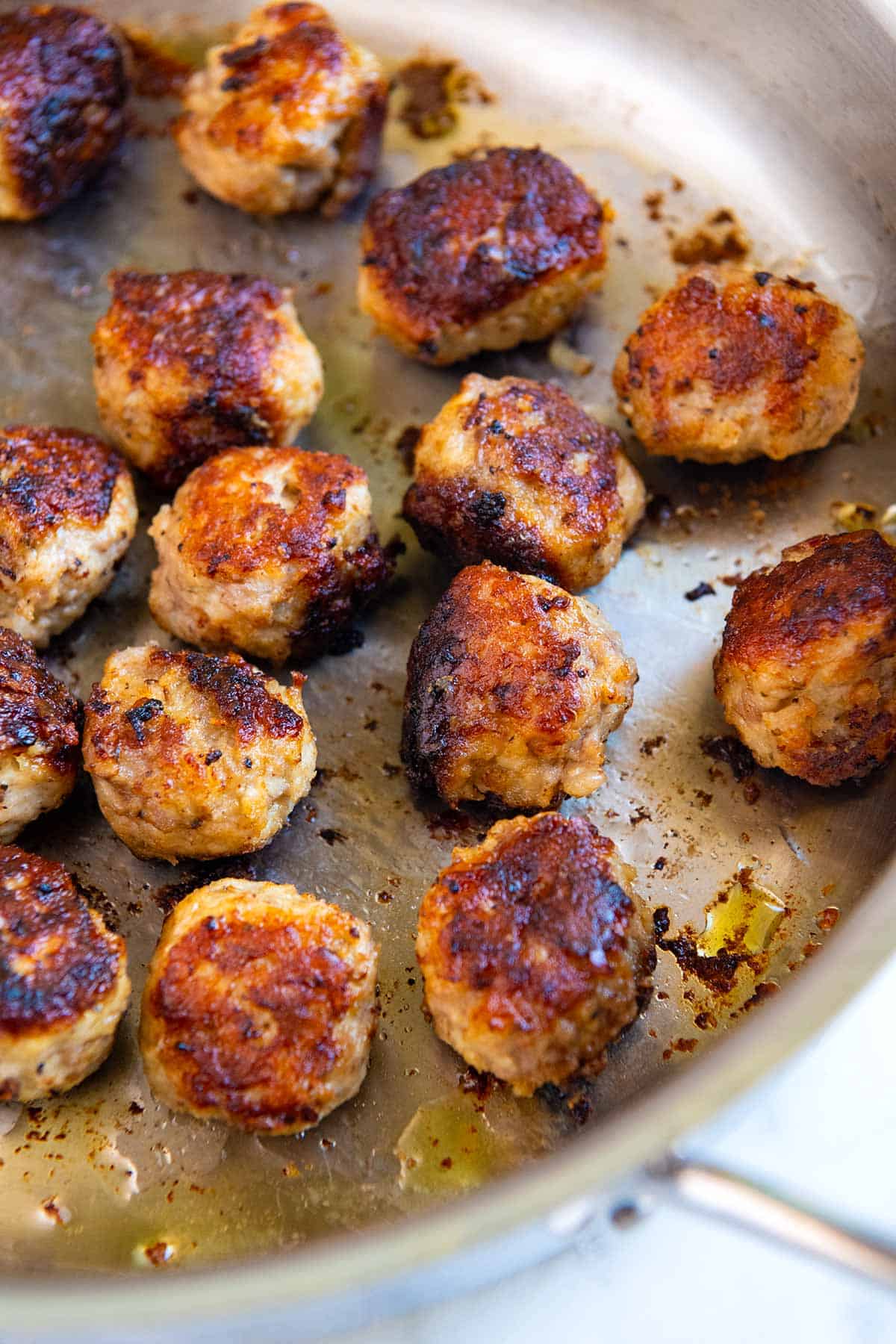 cooking meatballs in a skillet on the stove