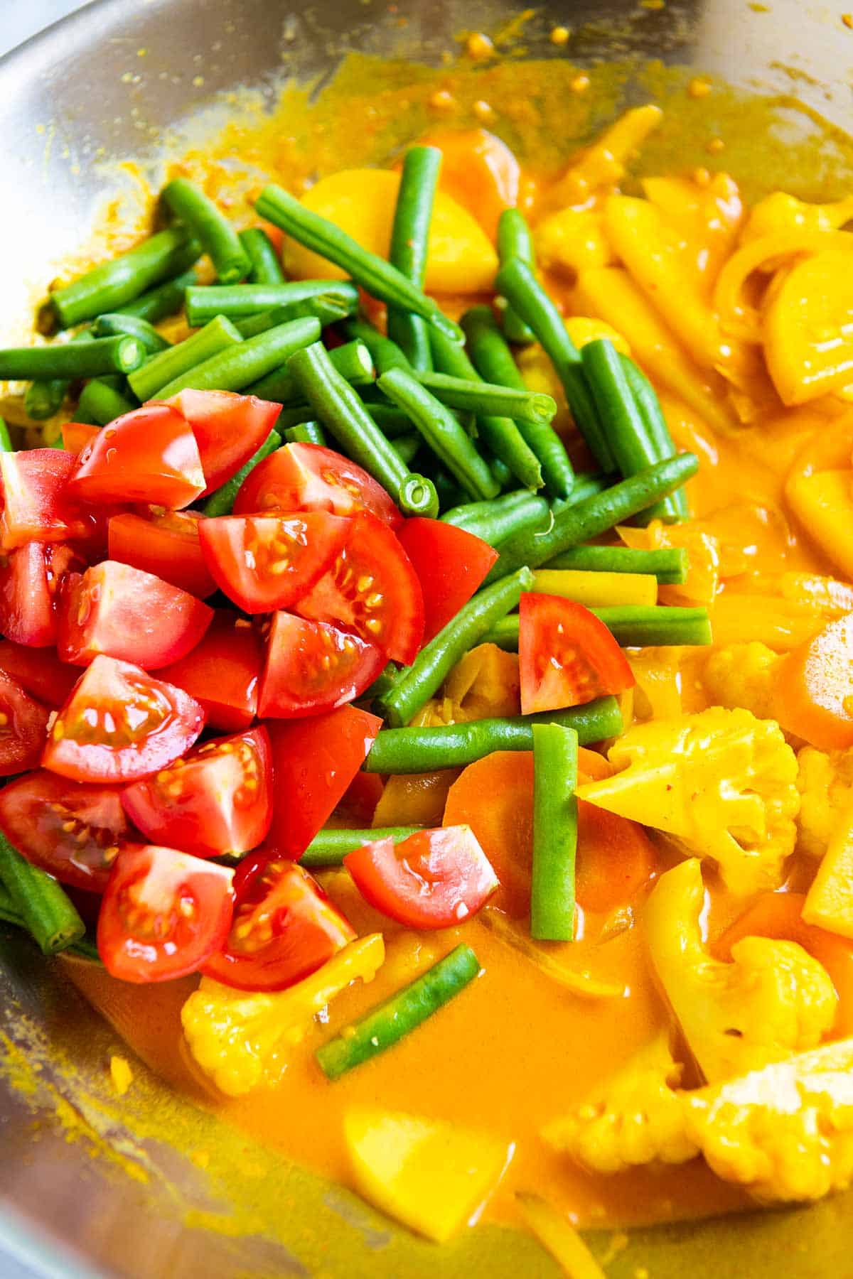 Tossing in fresh tomatoes and green beans