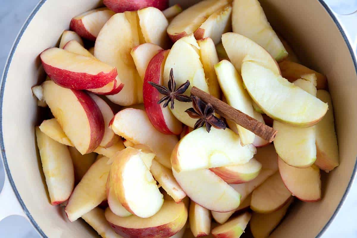 Apples in a pot with cinnamon ready to cook applesauce.