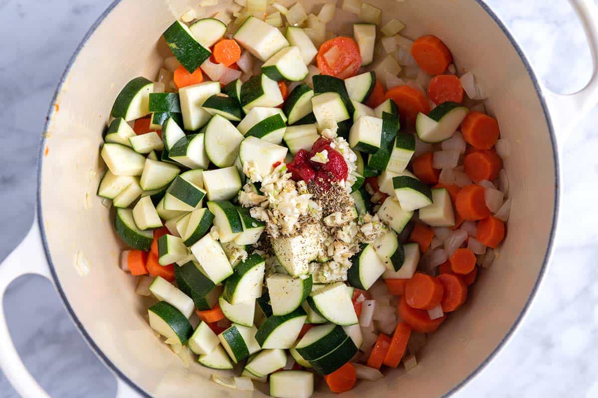 Cooking veggies with garlic, tomato paste and herbs for tortellini soup