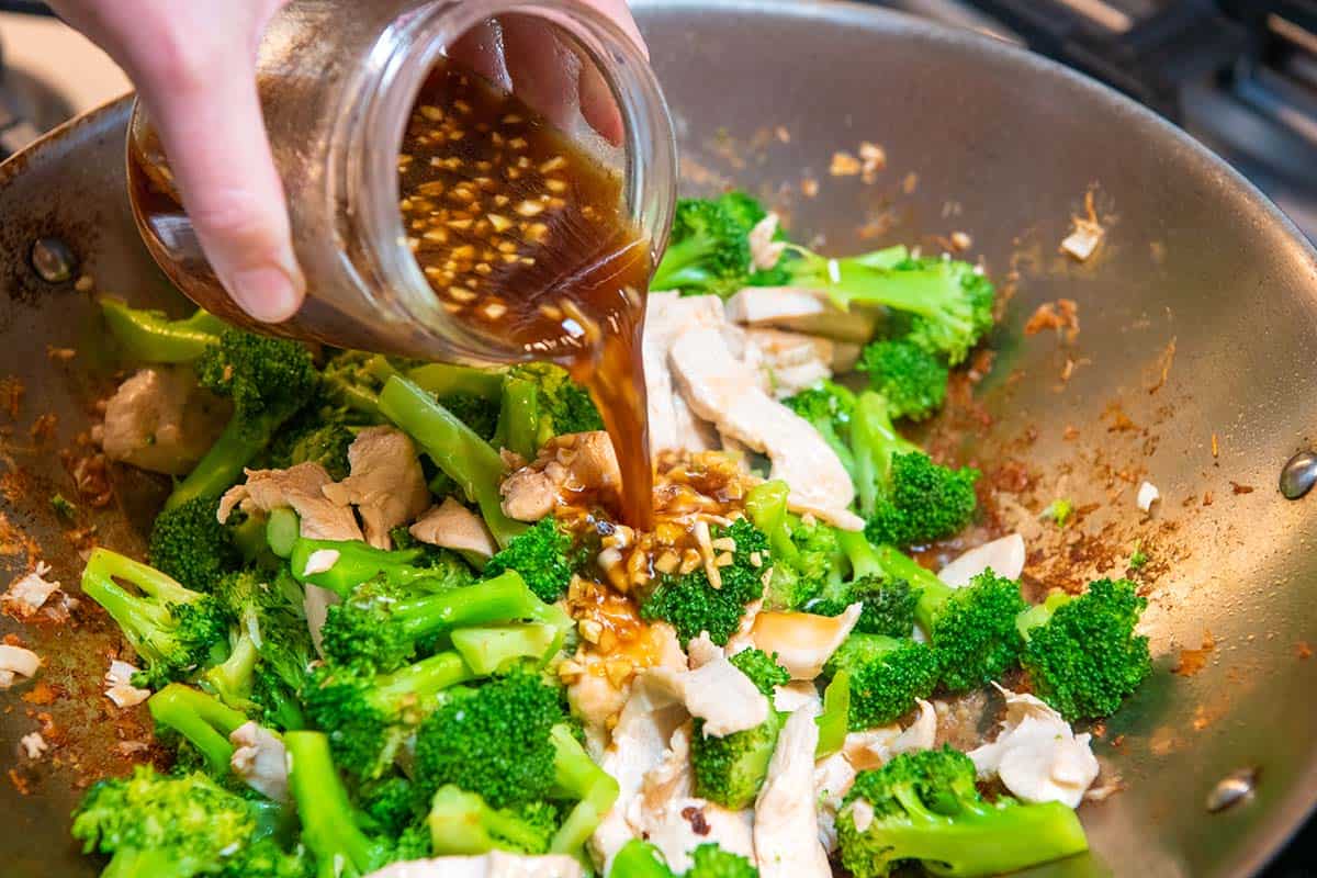 Adding the stir fry sauce to stir fry