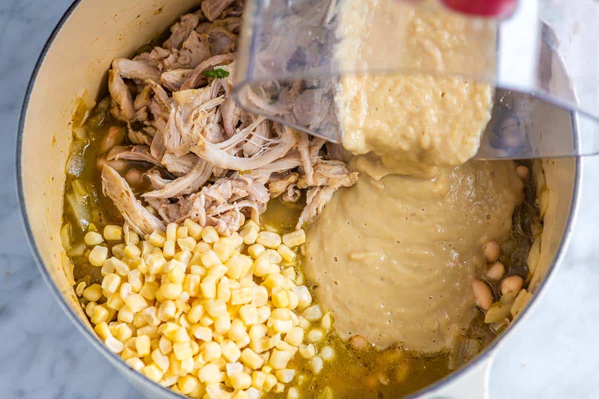 Stirring pureed white beans back into white bean chicken chili.