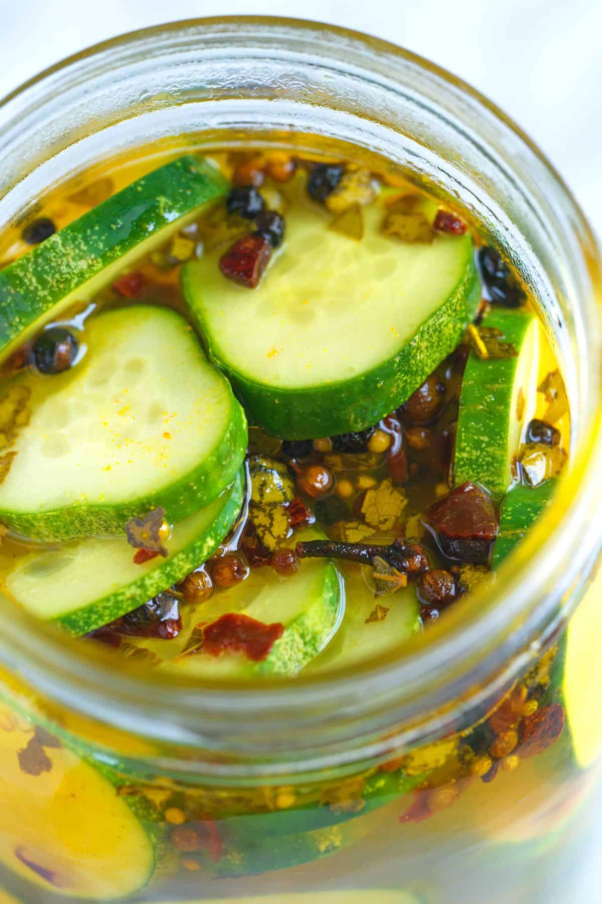 Sliced cucumbers with hot brine to make bread and butter pickles