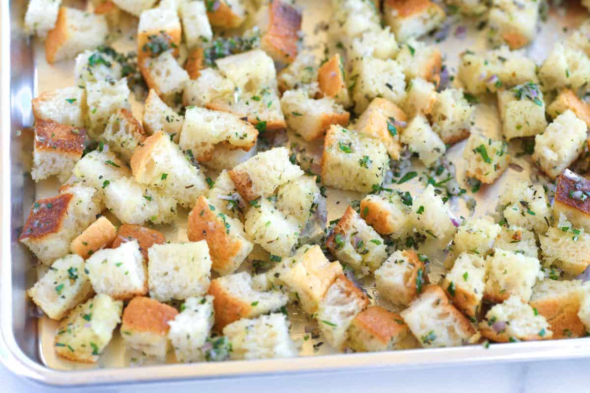 How to Make Garlic Croutons: Bread cubes on a baking sheet ready to go into the oven 