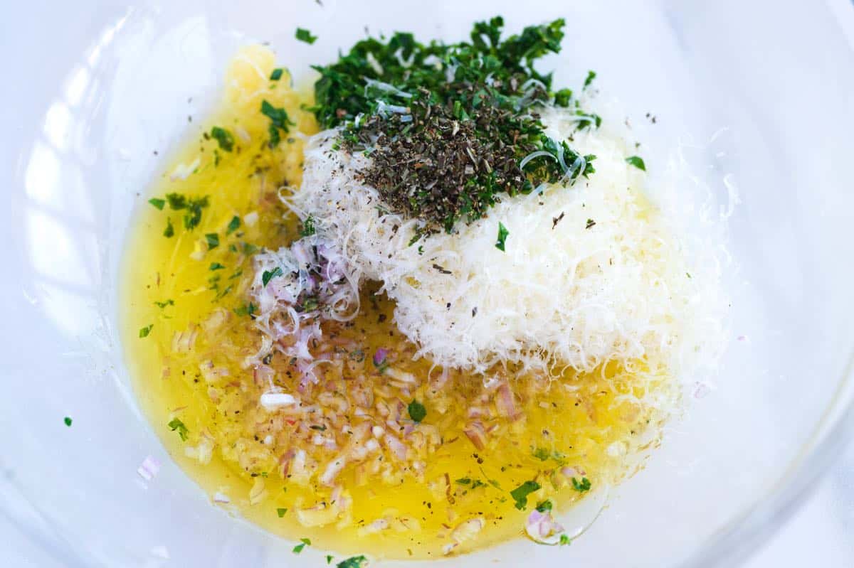 How to Make Garlic Croutons: ingredients in a bowl (garlic, shallot, parmesan, and herbs)