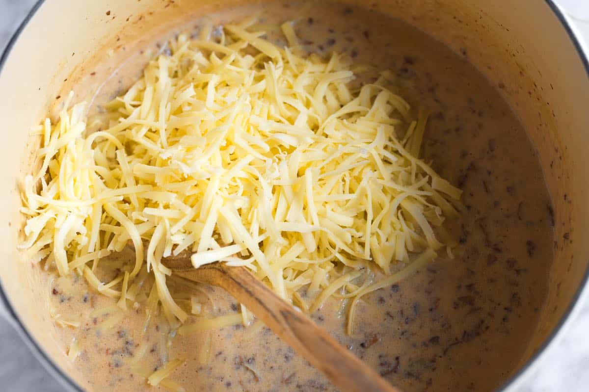 Adding cheese to our sauce.