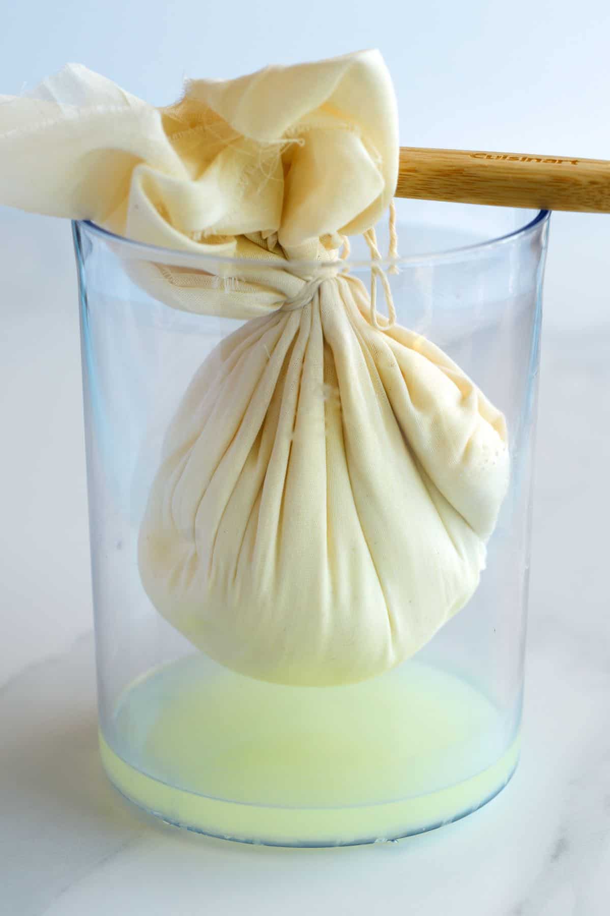 How to Make Labneh: Stained yogurt with salt hanging in a container