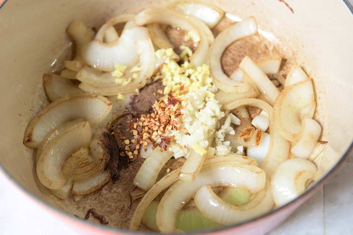 Cooking onions and spices in a pot for homemade ketchup