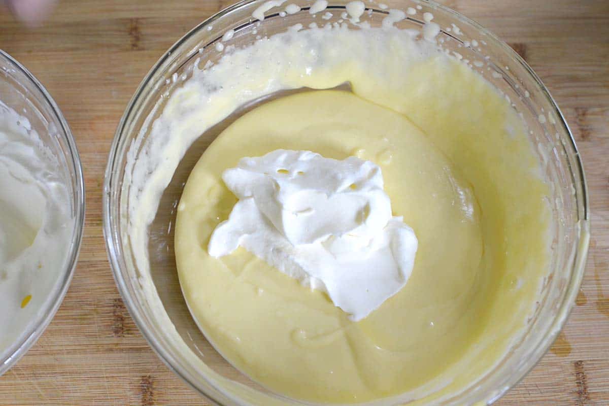 Folding the whipped cream into the mascarpone and Zabaglione mixture.