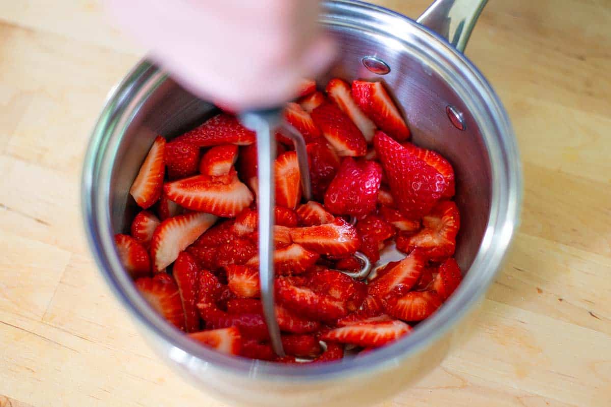How to Make Strawberry Pie Recipe Step - Mashing strawberries for the strawberry glaze.