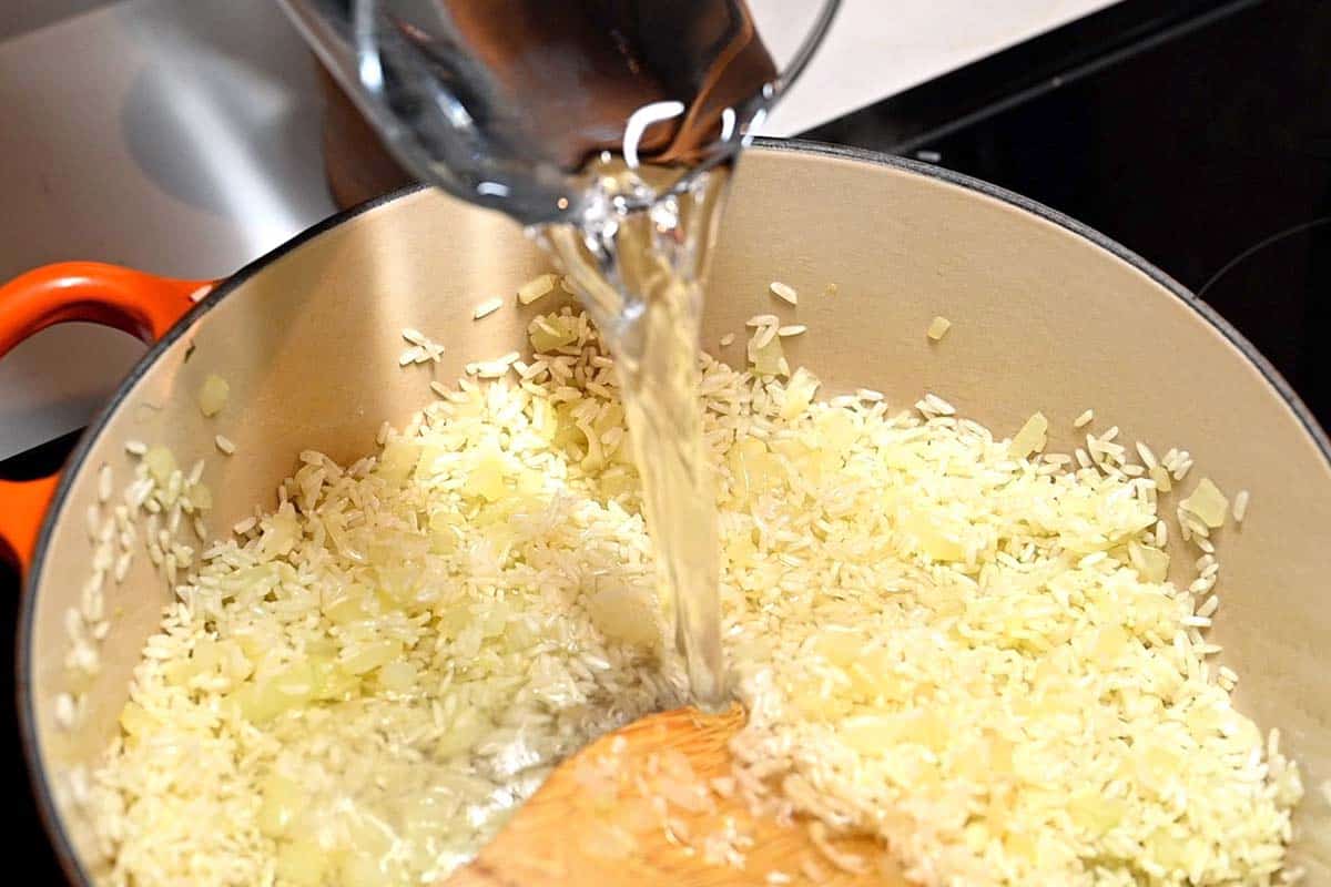 Toasting the rice with oil and onion before adding water.