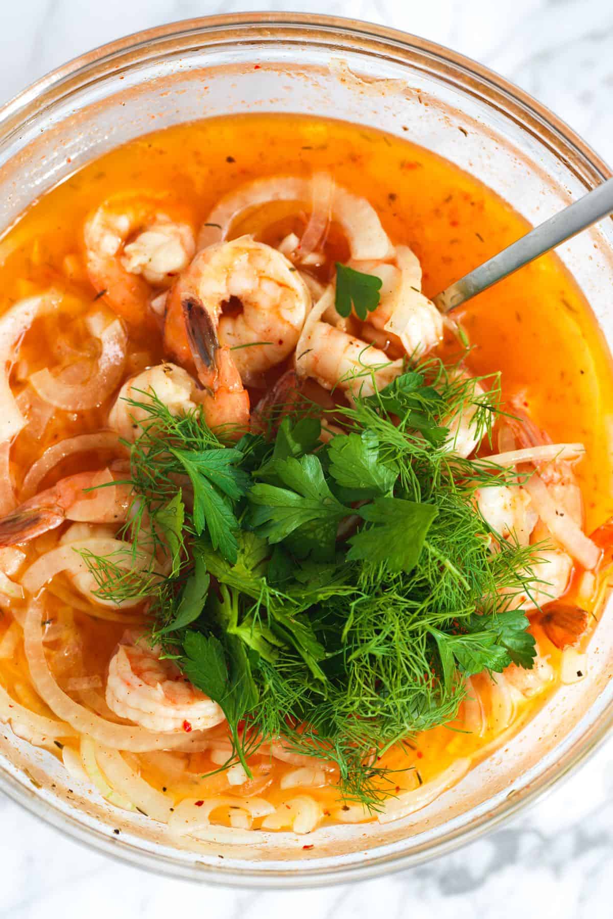 Tossing shrimp in pickled shrimp brine