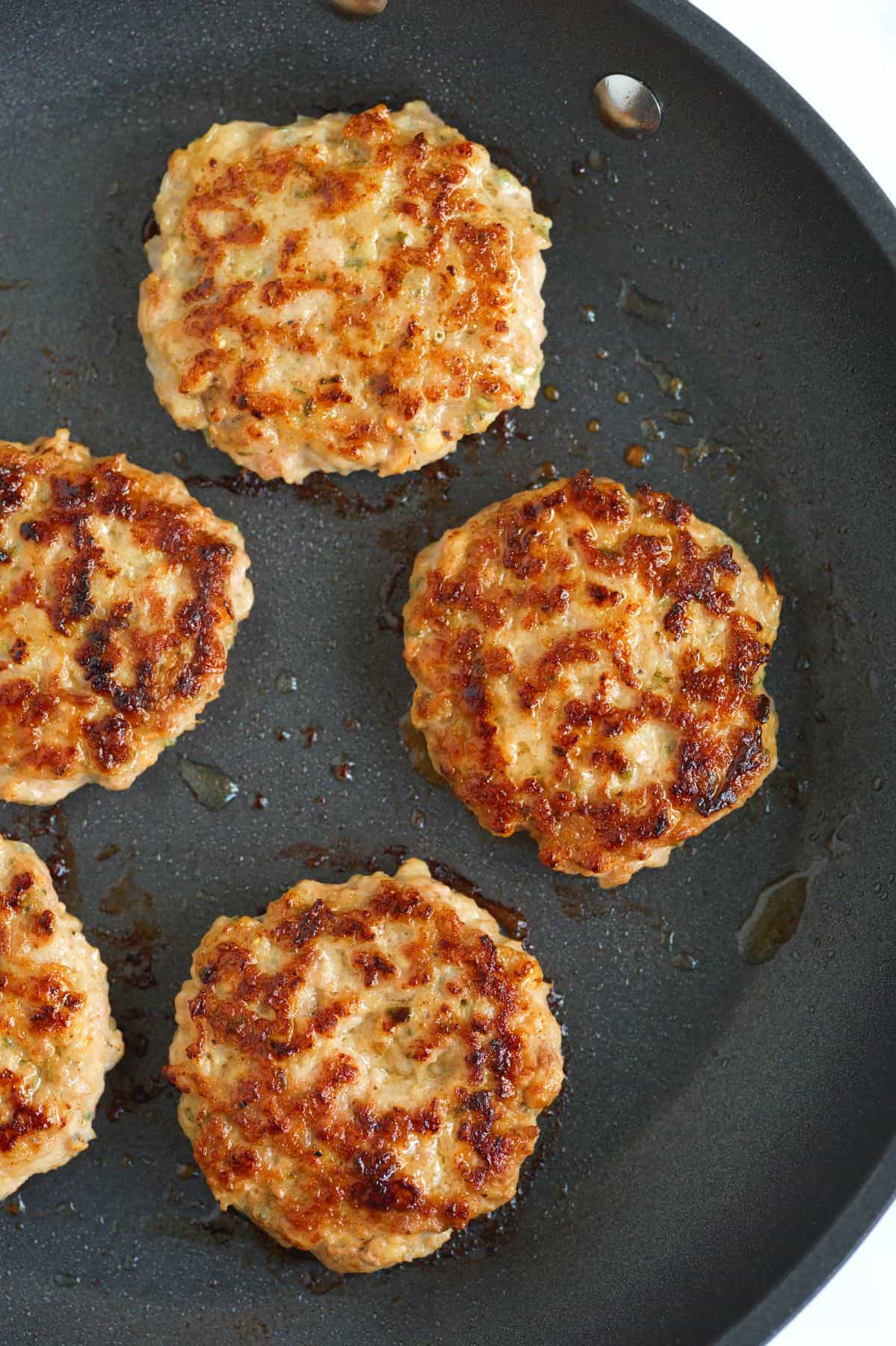 Breakfast sausage cooking in a skillet