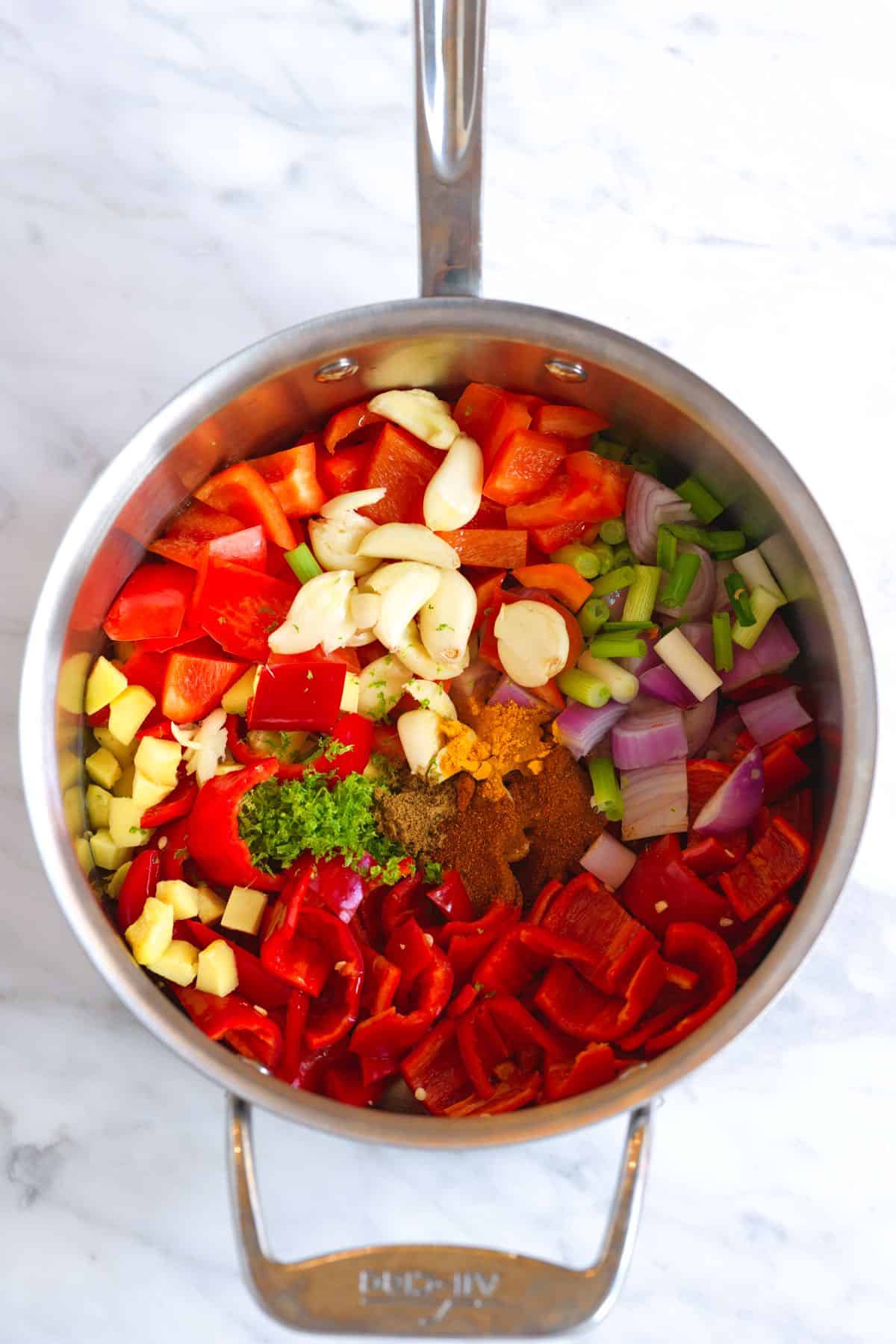 Red curry ingredients in a saucepan
