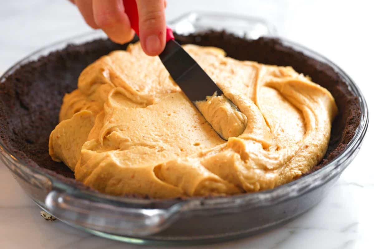 Spreading pie filling in the cookie crust