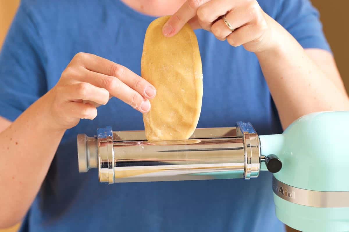 First roll of fresh pasta dough through pasta roller on setting #1