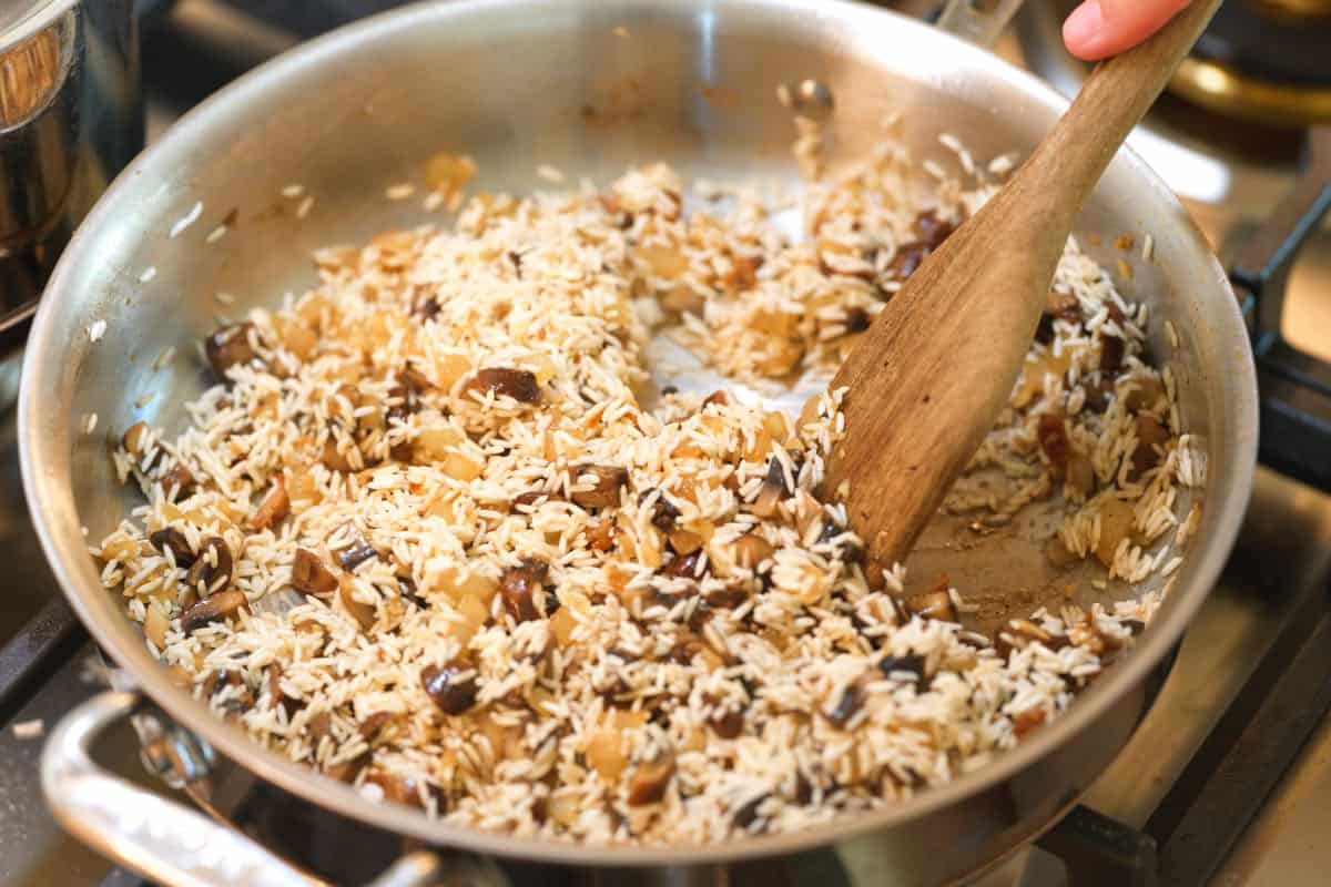 How to Make Chicken and Rice Recipe Step: Toasting the rice before adding broth and the chicken.
