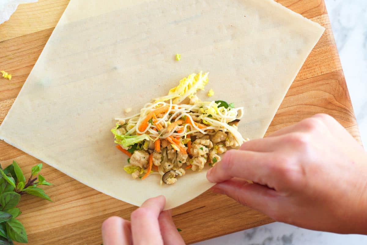 Rolling spring rolls in a wrapper