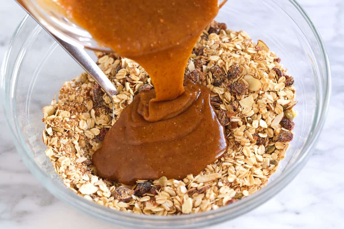 How to Make Baked Granola Bars: Mixing the oats with nuts, dried fruit, honey, and olive oil