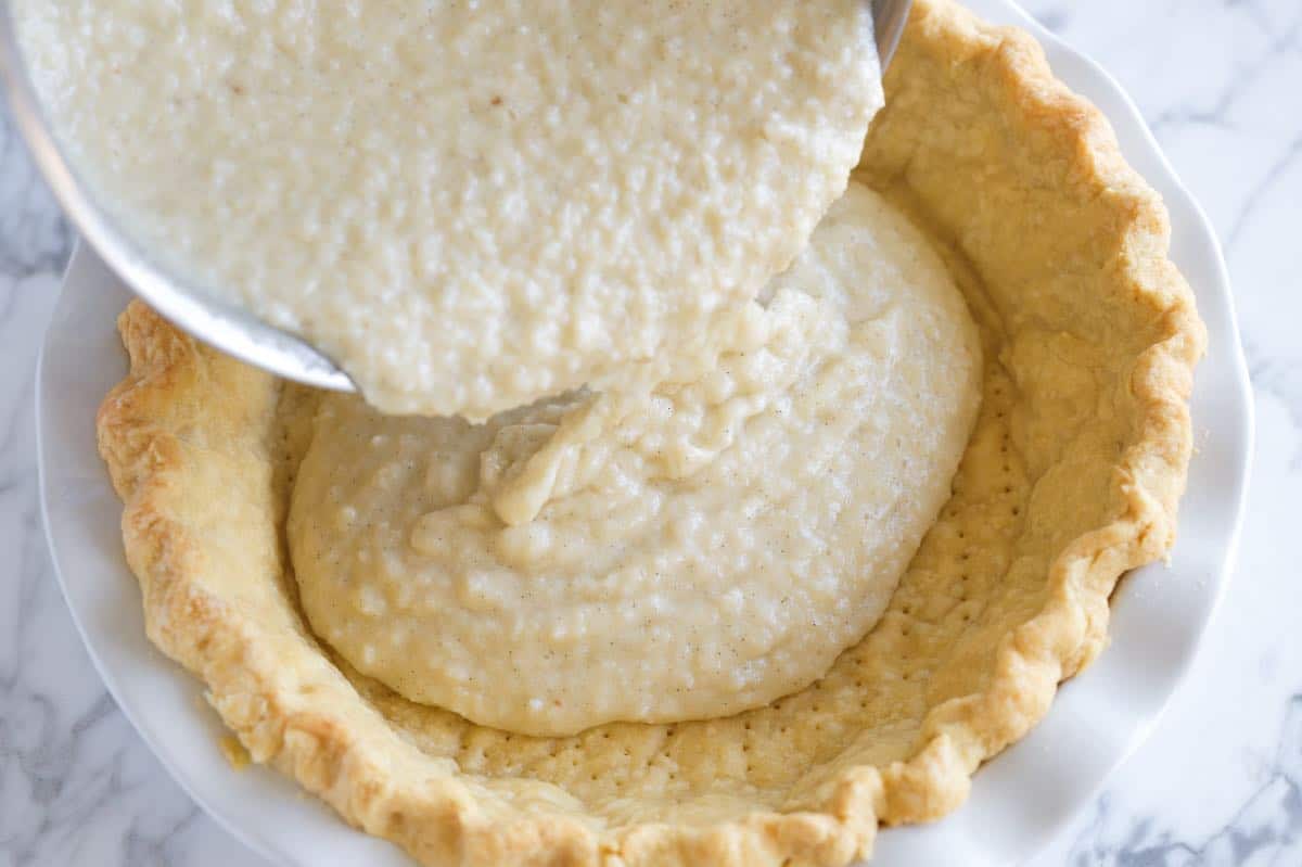 Pouring the coconut filling into the pie shell
