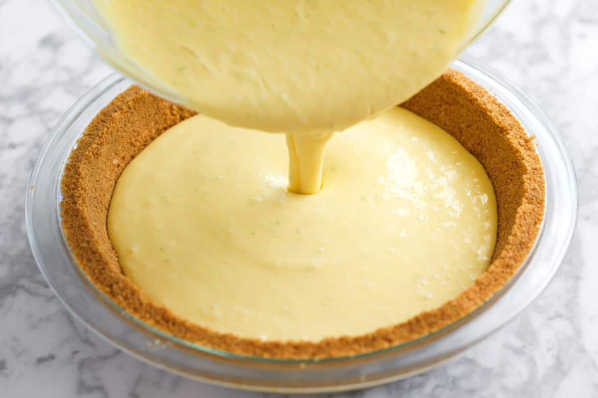 Pouring the filling into a graham cracker crust