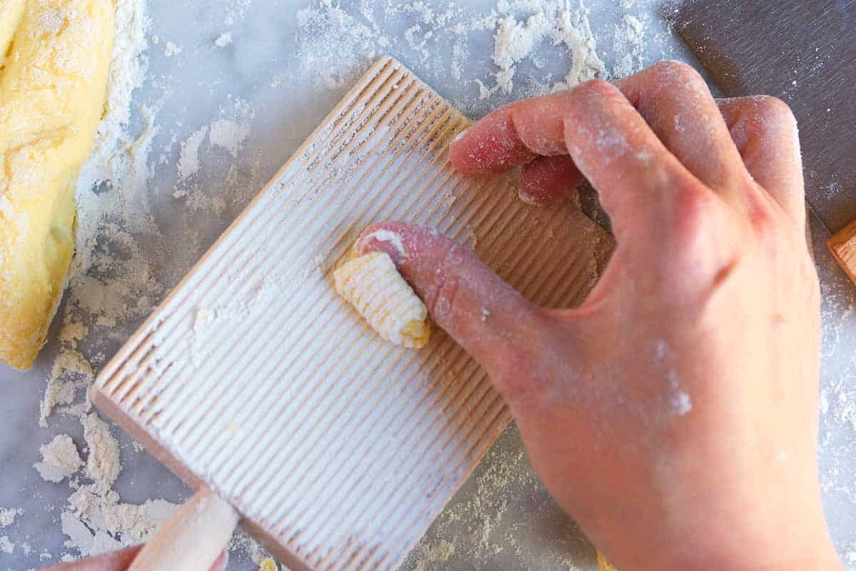 Rolling the dough on a gnocchi board