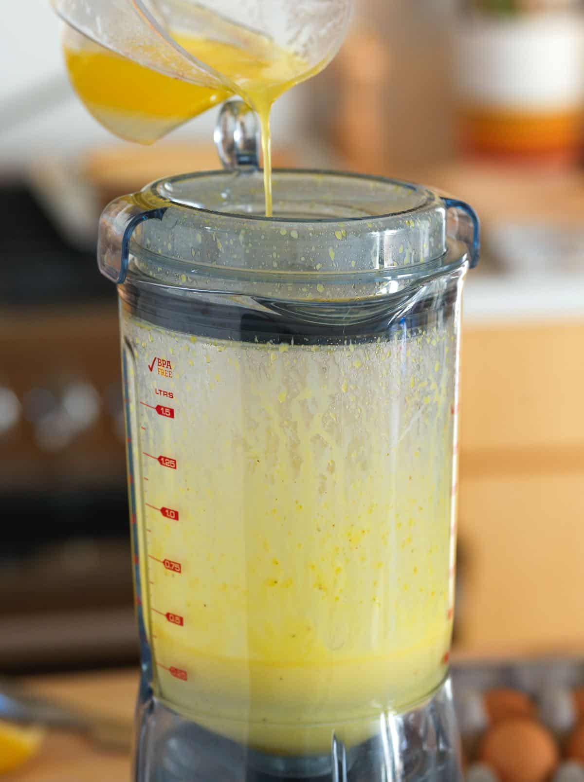 Streaming hot butter into a blender with egg yolks