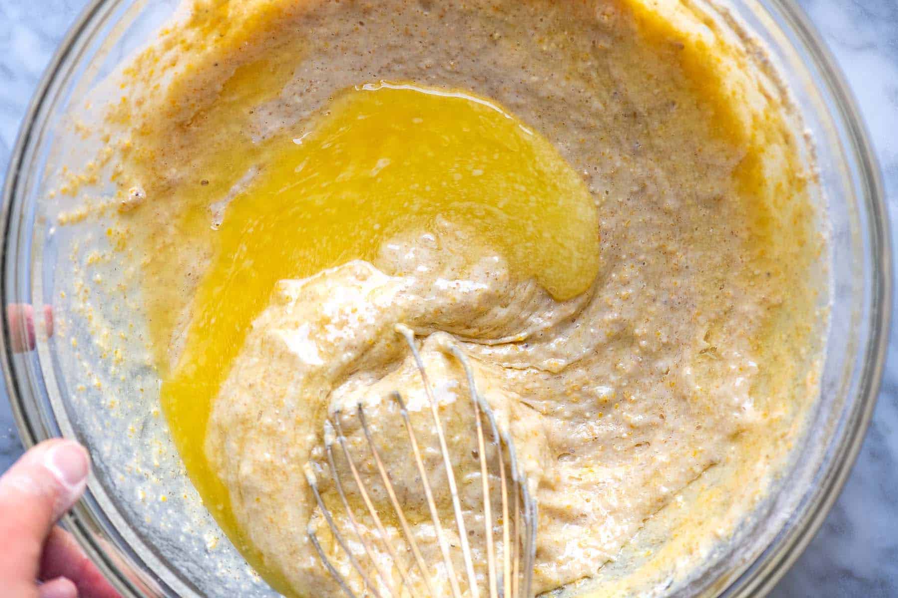 Whisking melted butter into the cornbread batter