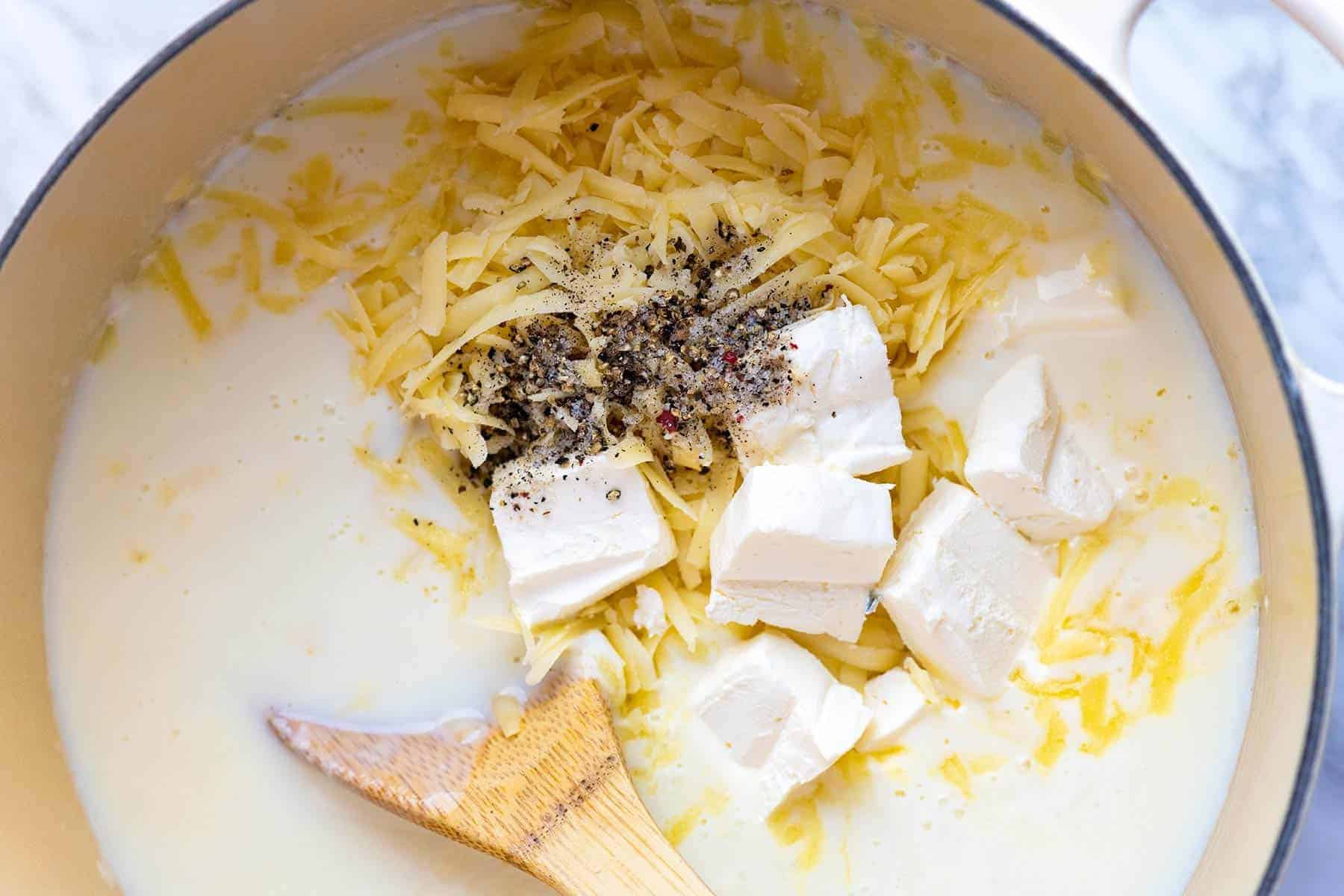 Making the best Mac and Cheese sauce with cheddar, cream cheese, and milk