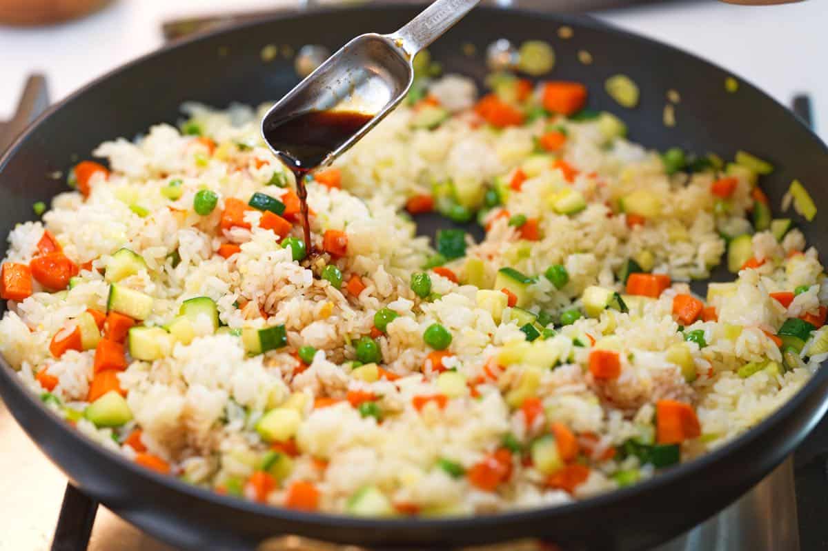 Adding sauce to fried rice