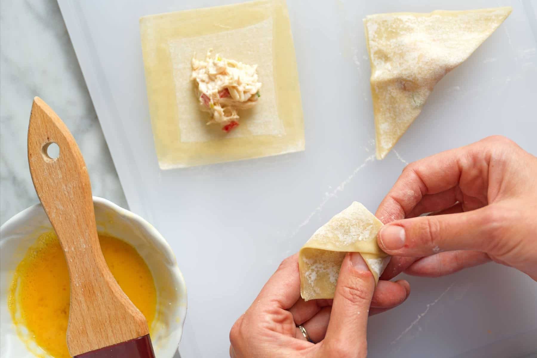Folding wontons for crab rangoon