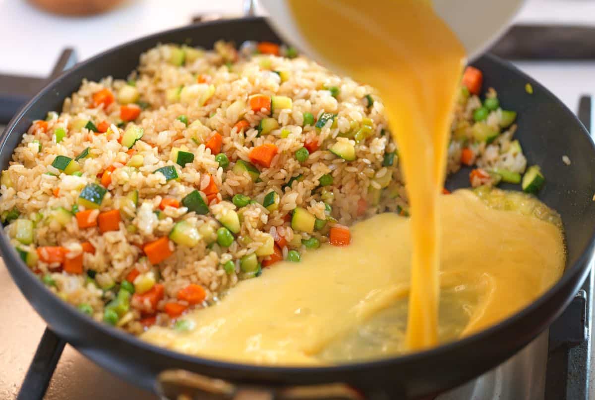 Adding egg to fried rice