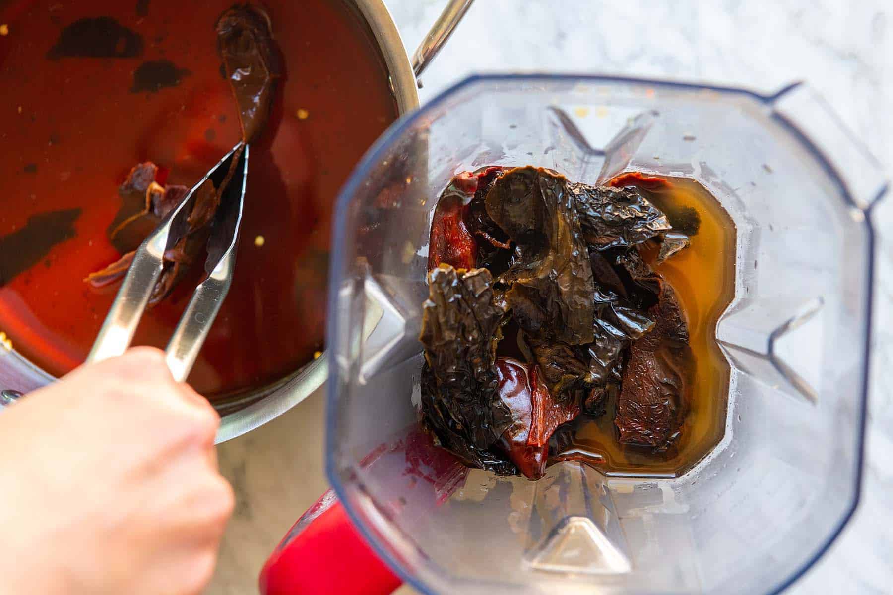 Blending softened dried chile peppers into a chili paste